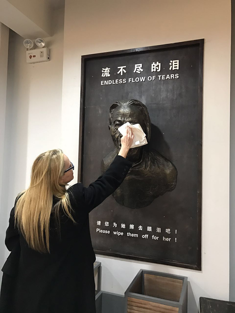 Karen Jungblut wipes tears at a display from the Comfort Women Museum in Nanjing. Tears actually run from eyes. Dec, 2016.