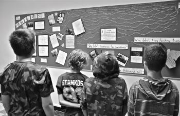 My students looking over the poster they created for our course on the Holocaust. 