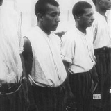 Romani (Gypsy) prisoners line up for roll call in the Dachau concentration camp. Germany, June 20, 1938.
Photo credit: Bundesarchiv, Bild 152-27/11A/Foto: Friedrich Franz Bauer