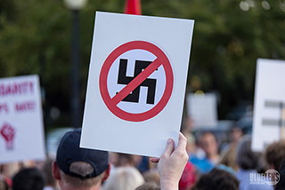 A counter-protester holds up a sign in Pittsburgh