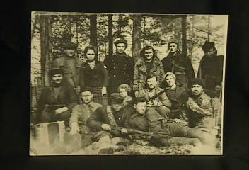 “This is a group of partisans, taken in 1943. I am in the center standing in the middle, with the leopard coat. And beside my right arm, in the center, is a little girl. This is Raika Kliger, the girl that I saved. And with many difficulties, I sent her to Moscow.”