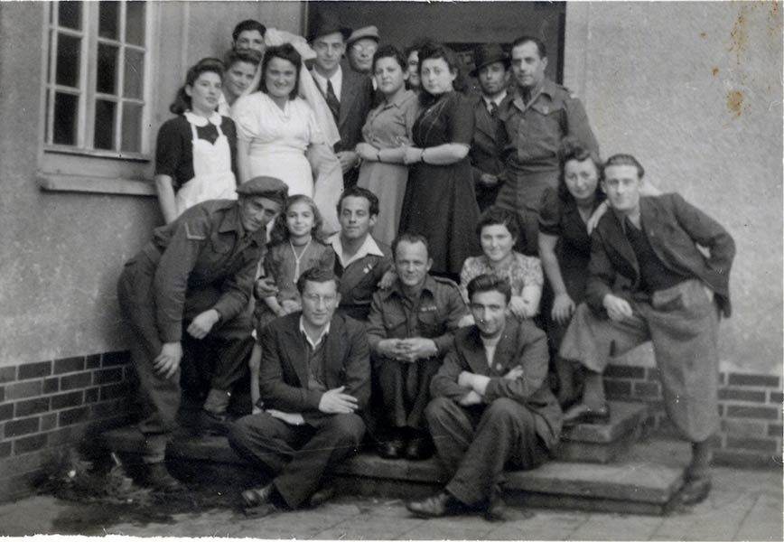 Yosef and Yona Bienenstock got married at Bergen-Belsen after being liberated. They are surrounded by Zionists and Jewish freedom fighters who nursed them back to health and found wedding outfits for them.