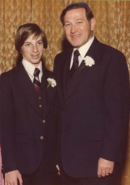 Joel, at his bar mitzvah with his father, spent years trying to get his father to tell him how he managed to survive as a young boy, alone.