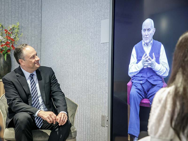Second Gentleman Douglas Emhoff speaks with the Dimensions in Testimony interactive biography of Holocaust survivor Pinchas Gutter, 2022.