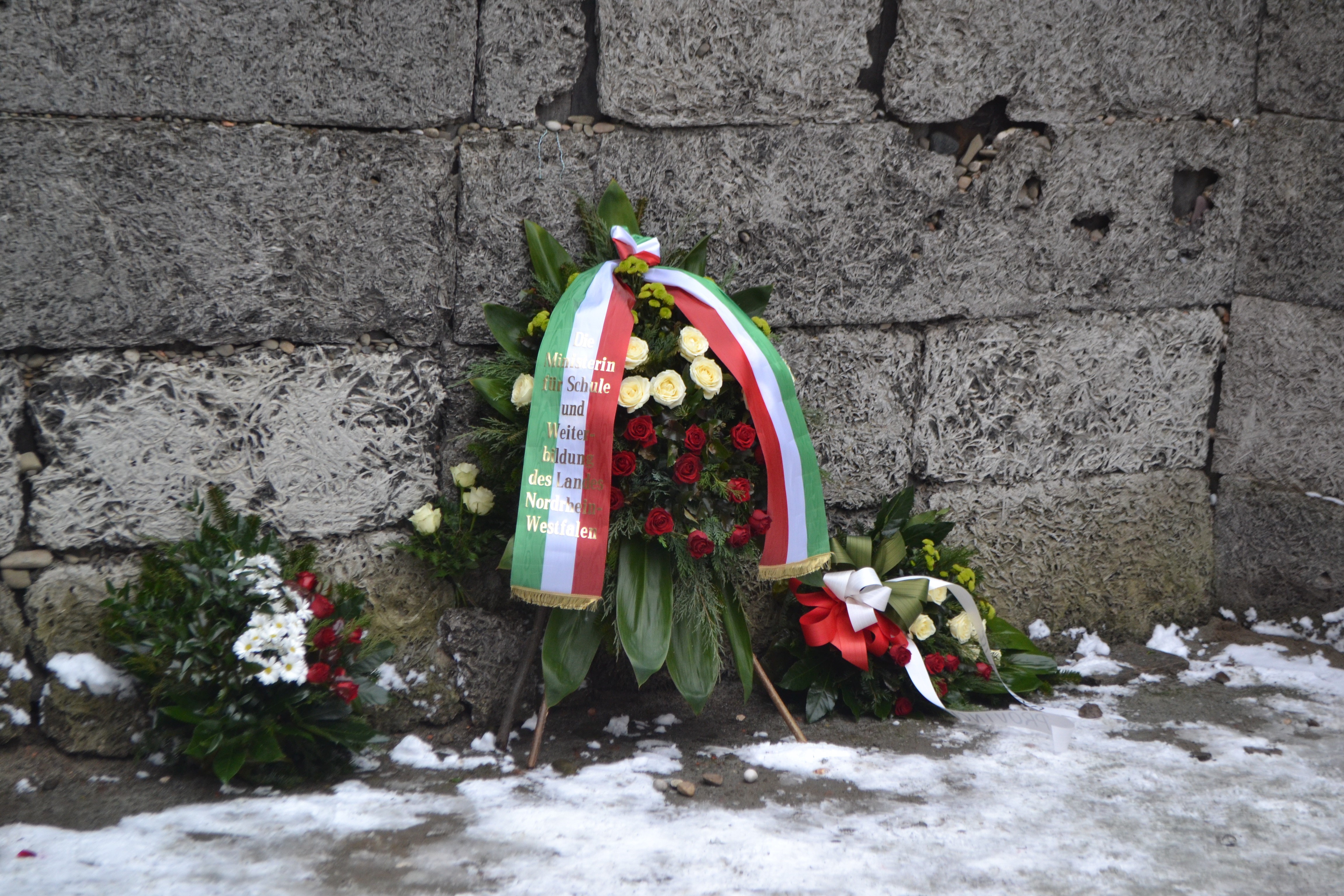 A photo of the &quot;death wall,&quot; in Auschwitz, surrounded by flowers left by delegations from around the world for the 70th anniversary liberation commemoration.