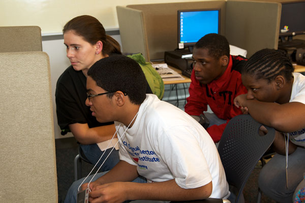 Comcast Digital Connectors teacher Christina Harrison working with students on their media project.