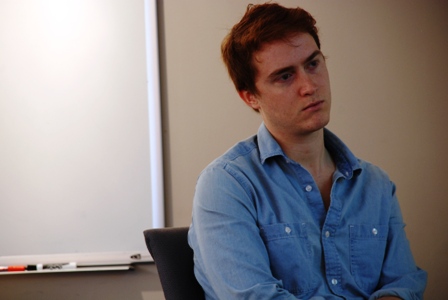 Jeremy Schwartz, a senior majoring in international relations, looks on during another student's presentation.  Schwartz screened his documentary film, 