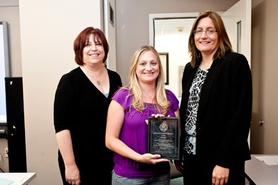 Sherry Bard, Institute Project Director of Educational Programs (left); and Sheila Hansen, Institute Senior Trainer and Content Specialist (right), present Teresa Hill (center), a teacher at Downey High School, with a plaque in honor of her completion of a testimony-based project.