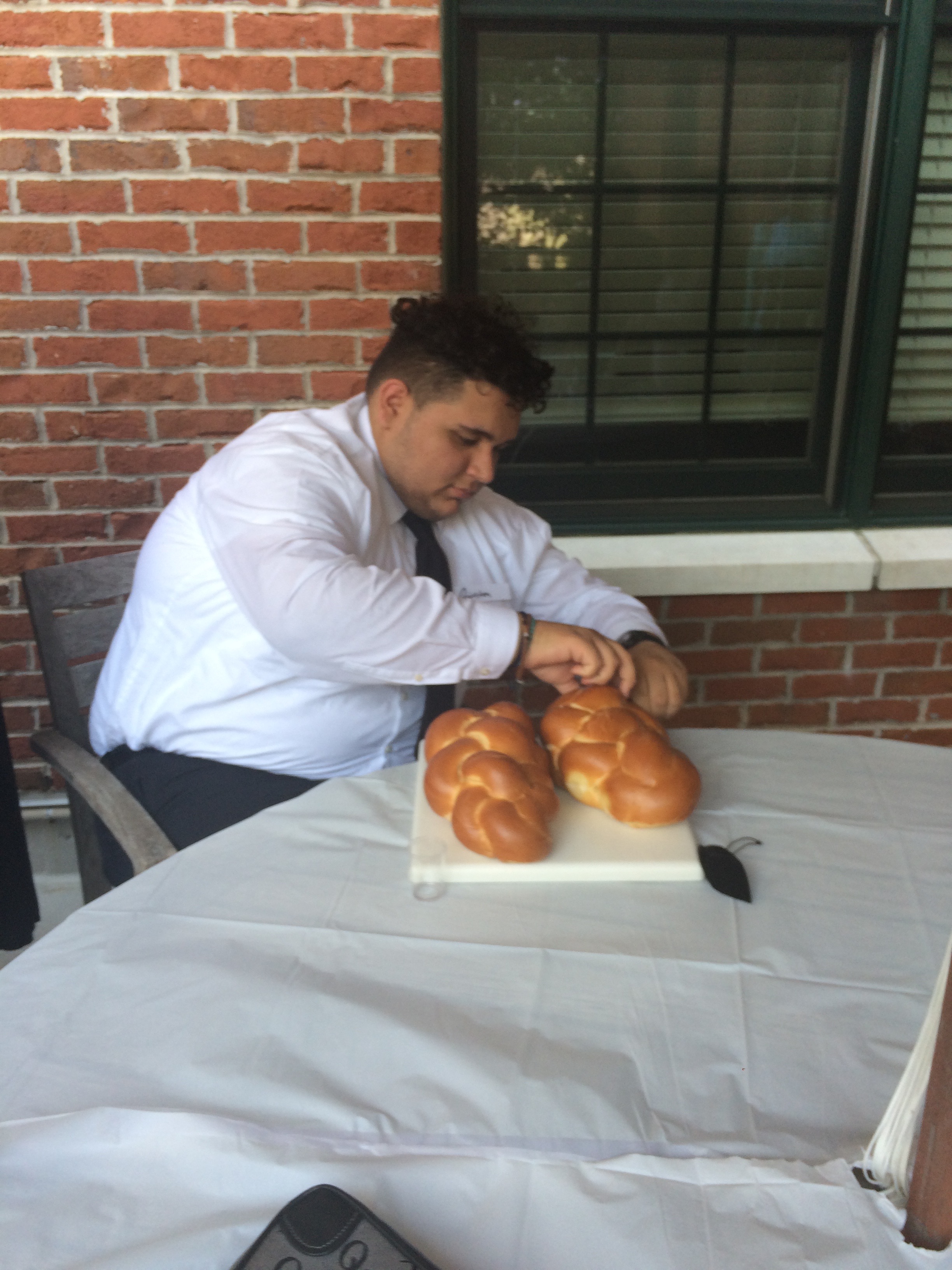 Quinten taking challah bread