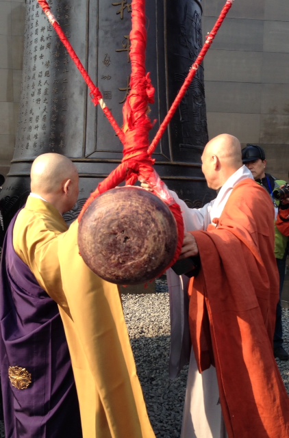 Buddhist monks ringing the memorial bell