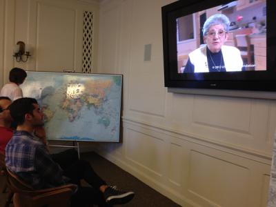 Visitors watch an informational video at the exhibit.