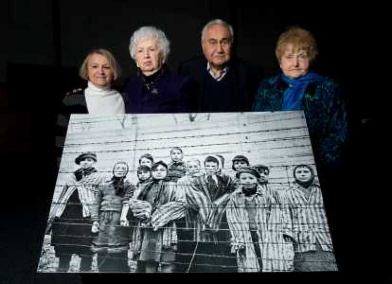 (L-R) Paula Lebovics, Miriam Ziegler, Gabor Hirsch and Eva Kor pose with the original image of them as children taken at Auschwitz at the time of its liberation on January 26, 2015 in Krakow, Poland. (L-R) Paula Lebovics, Miriam Ziegler, Gabor Hirsch and Eva Kor pose with the original image of them as children taken at Auschwitz at the time of its liberation on January 26, 2015 in Krakow, Poland.