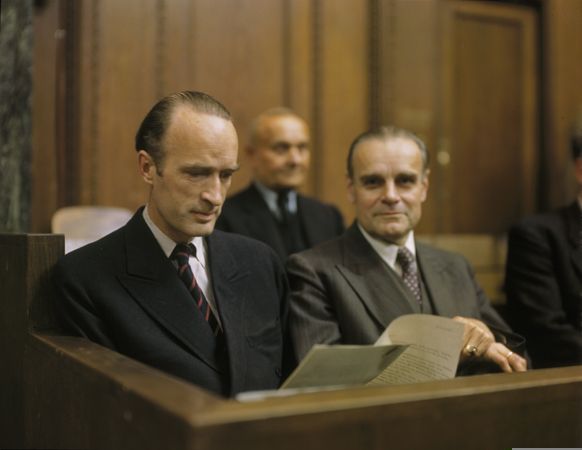 Alfried Krupp von Bohlen und Halbach reading a document, seated in the dock, as a defendant at the Krupp Trial. Credit: Stadtarchiv Nürnberg