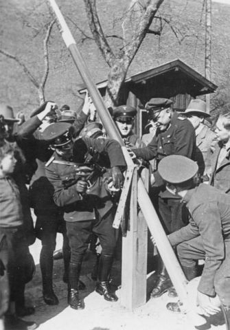 German and Austrian border police dismantle a border post on March 15, 1938. German and Austrian border police dismantle a border post on March 15, 1938.