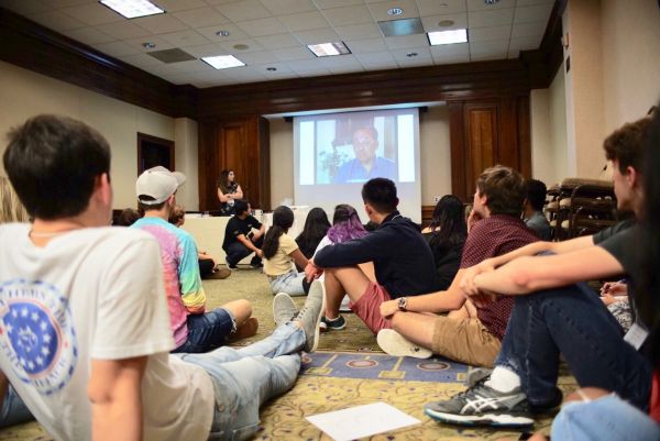 Members of USC student government watch a clip of testimony by liberator Leon Bass.