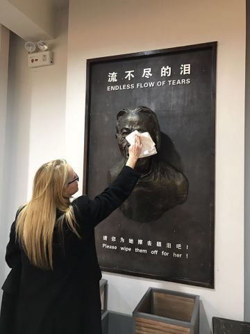 Karen Jungblut wipes tears at a display from the Comfort Women Museum in Nanjing. Tears actually run from eyes. Dec, 2016. Karen Jungblut wipes tears at a display from the Comfort Women Museum in Nanjing. Tears actually run from eyes. Dec, 2016.