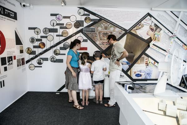 Visitors watch testimony in the POLIN "Museum on Wheels"