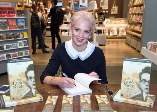 Noemie Lopian signs copies of her father's book.