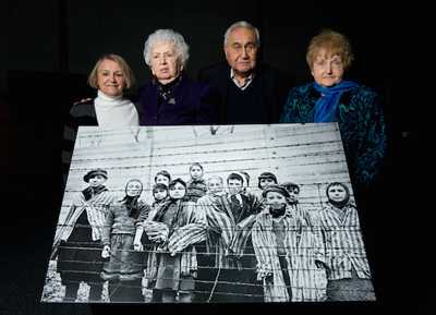 Survivors pose with an enlargement of the iconic photograph taken of them on Jan. 27, 1945. From left are Paula Lebovics, Miriam Ziegler, Gabor Hirsch and Eva Kor. (Photo courtesy of Ian Gavan/Getty Images) Survivors pose with an enlargement of the iconic photograph taken of them on Jan. 27, 1945. From left are Paula Lebovics, Miriam Ziegler, Gabor Hirsch and Eva Kor. (Photo courtesy of Ian Gavan/Getty Images)