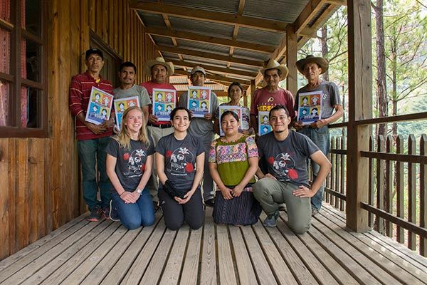 Lucia Samayoa (second from left in the front) and three other employees with FAFG (all in the front row) pose with a group of Guatemalan genocide survivors whose testimonies were taken by FAFG. The FAFG employee on the second-to-right is the interviewer