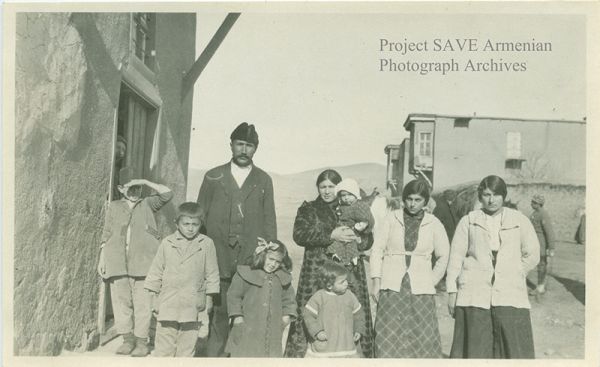 This photograph is one of many from the album of Near East Relief volunteer worker Ruth Woodis of Worcester, Massachusetts from the early 1920s. With her Brownie box camera, Ruth photographed daily living situations. She was in charge of food and clothing for the Armenian orphans, and trained them in the tailor and shoe shops. The woman second from the right is Haiastan Terzian, who was a mayrig (caregiving mother) of the Near East Relief orphanage in Kharpert, Ottoman Empire, where Ms. Woodis worked. This photograph is courtesy of Ruth Woodis.